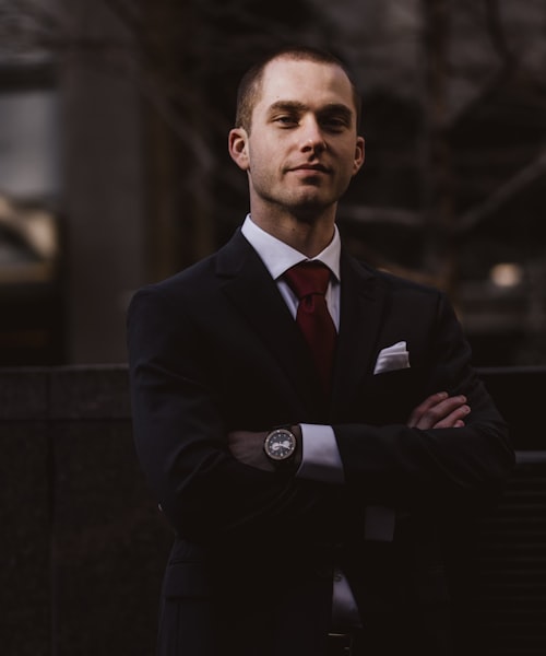 Attorney in a suit with arms crossed, partner at Ashraf & Associates