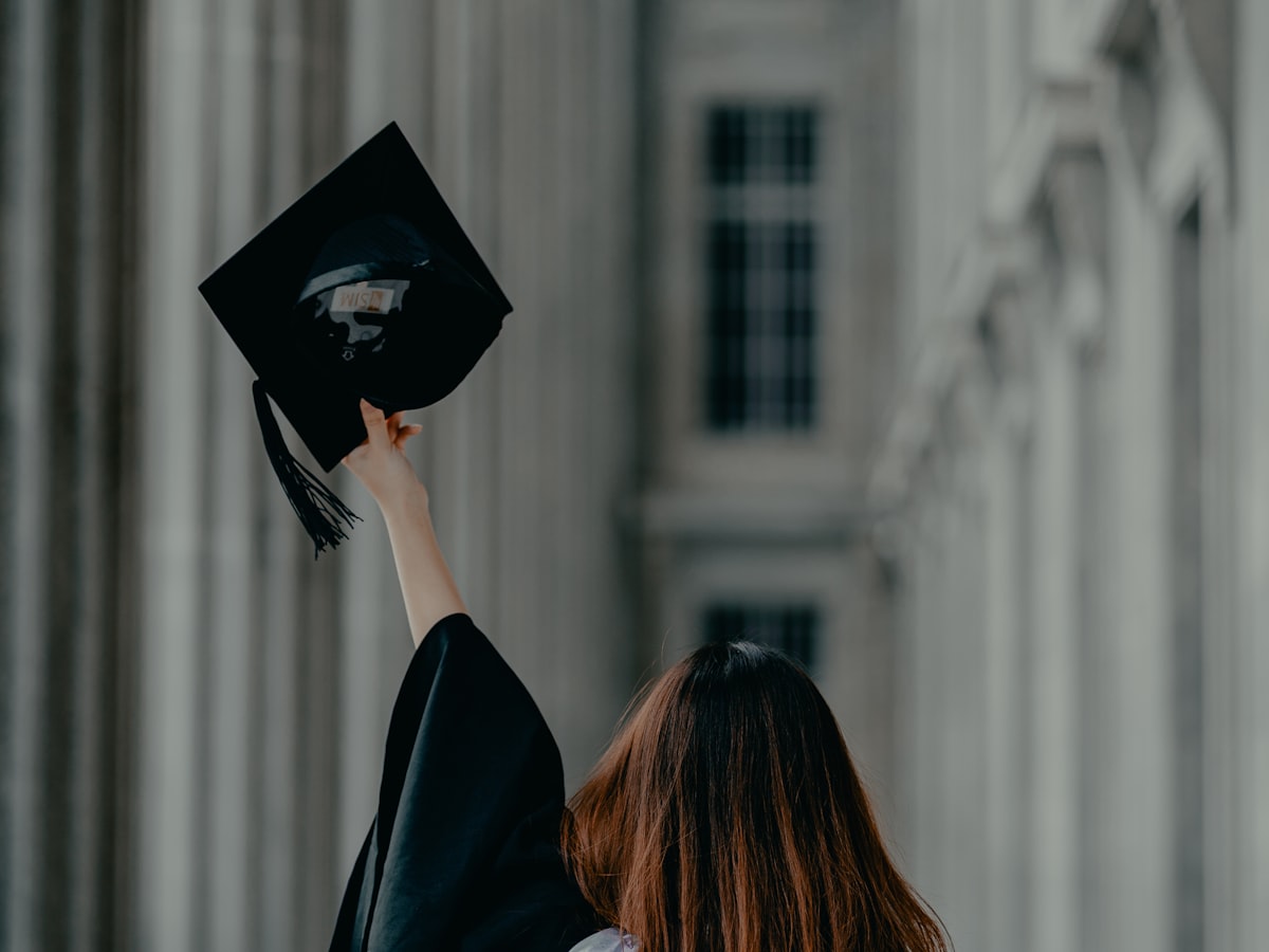 Graduates in caps and gowns celebrating at their university graduation ceremony